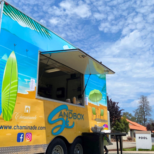 A colorful food truck, labeled 